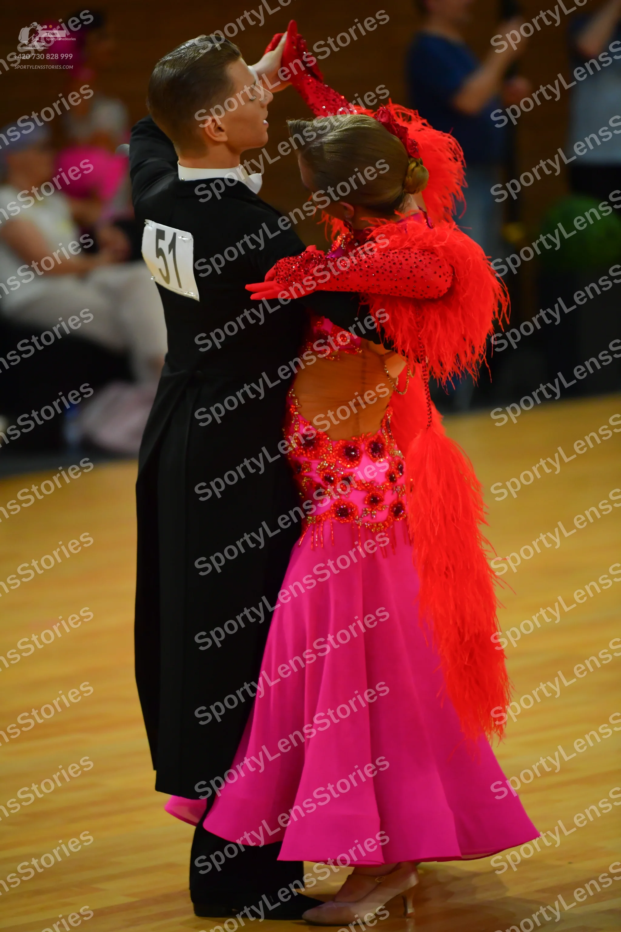 Dancesport competitor: Black suit with a tailcoat over it