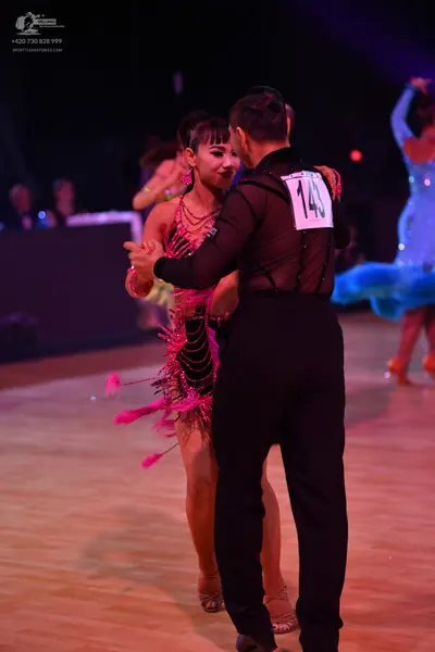 Dancesport competitor: Male dancer: black long-sleeved shirt and black trousers