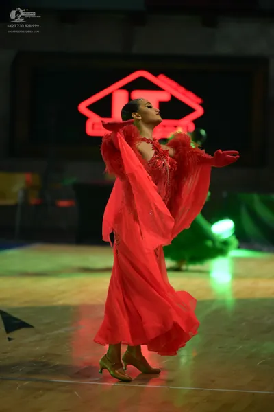 Dancesport competitor: ** Red Latin Dress
*   **Color:** Vibrant Red
*   **Fabric:** Appears to be sati