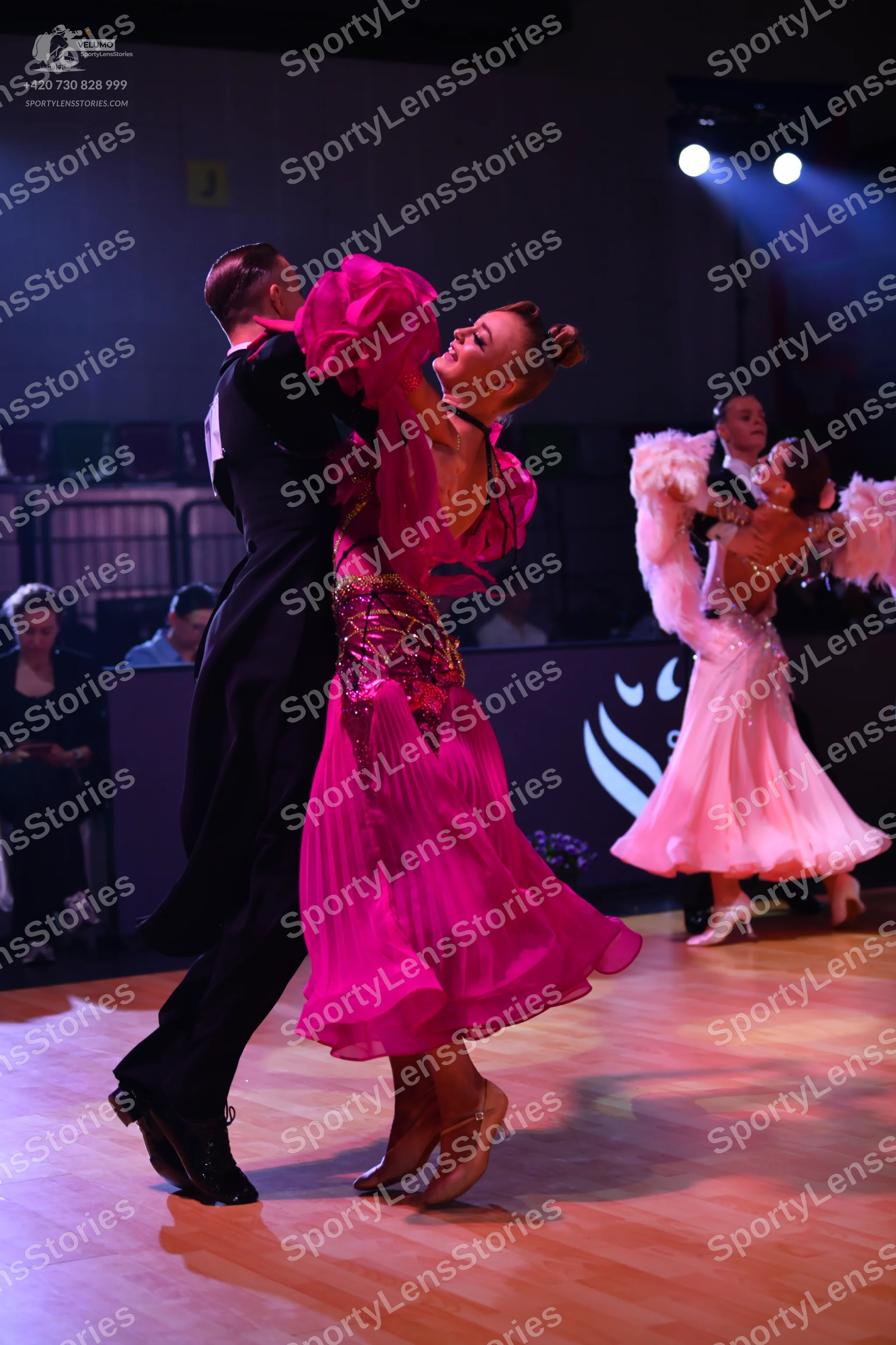 Dancesport competitor: Male dancer (foreground): black ballroom suit and white shirt
