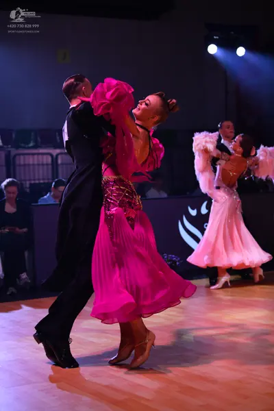 Dancesport competitor: Male dancer (foreground): black ballroom suit and white shirt