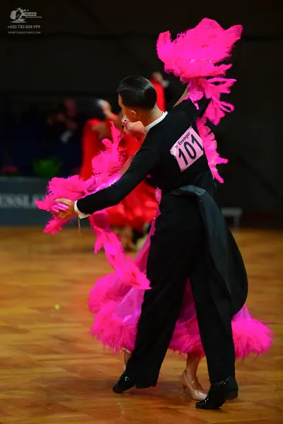 Dancesport competitor: Male dancer: black long-sleeved top and black trousers