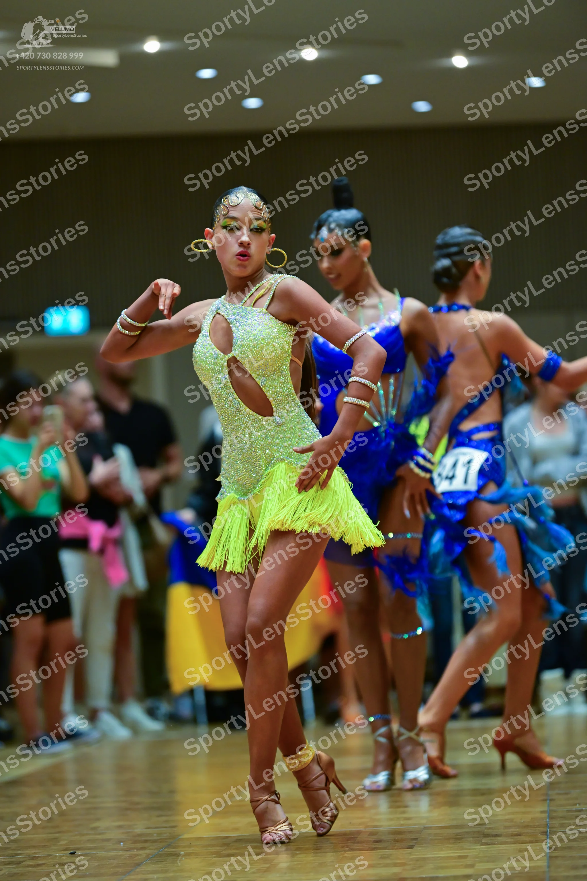 Dancesport competitor #41: First dancer: lime green sequined Latin dress with cutouts and fringe skirt, acc