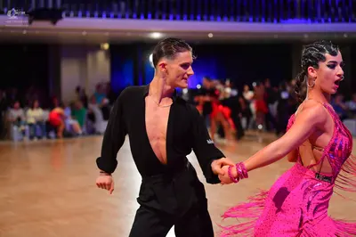 Dancesport competitor: Male dancer: black long-sleeved shirt and black trousers