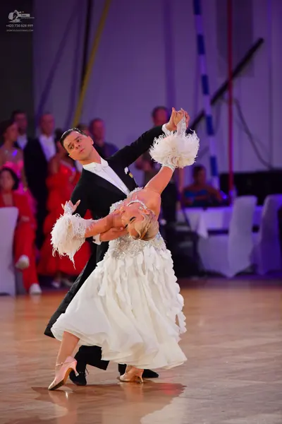 Dancesport competitor: Male dancer: black suit with a white shirt and white bowtie