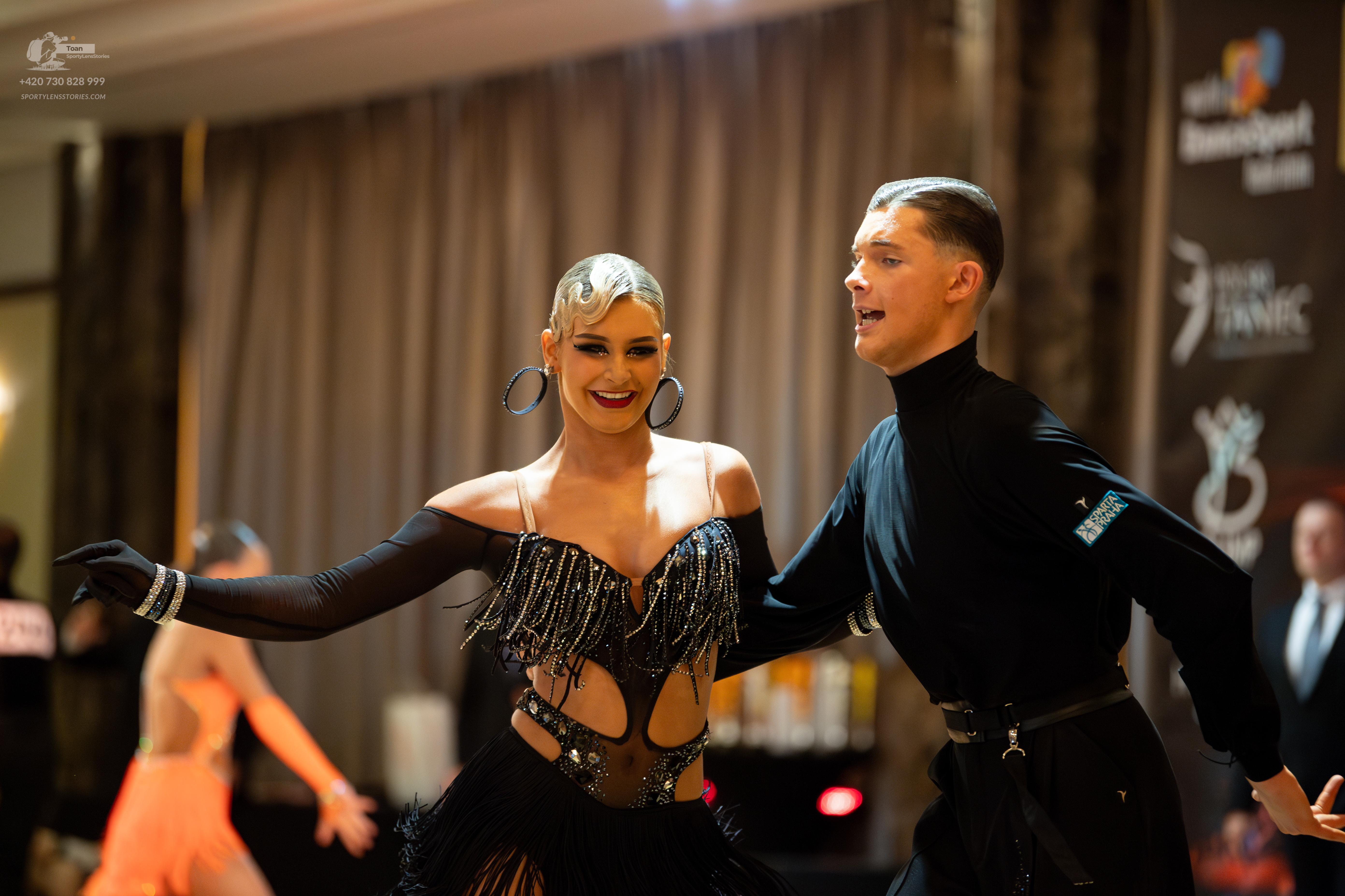 Dancesport competitor: Main female dancer: black latin dance dress with sequin fringe, cut-out bodice, 
