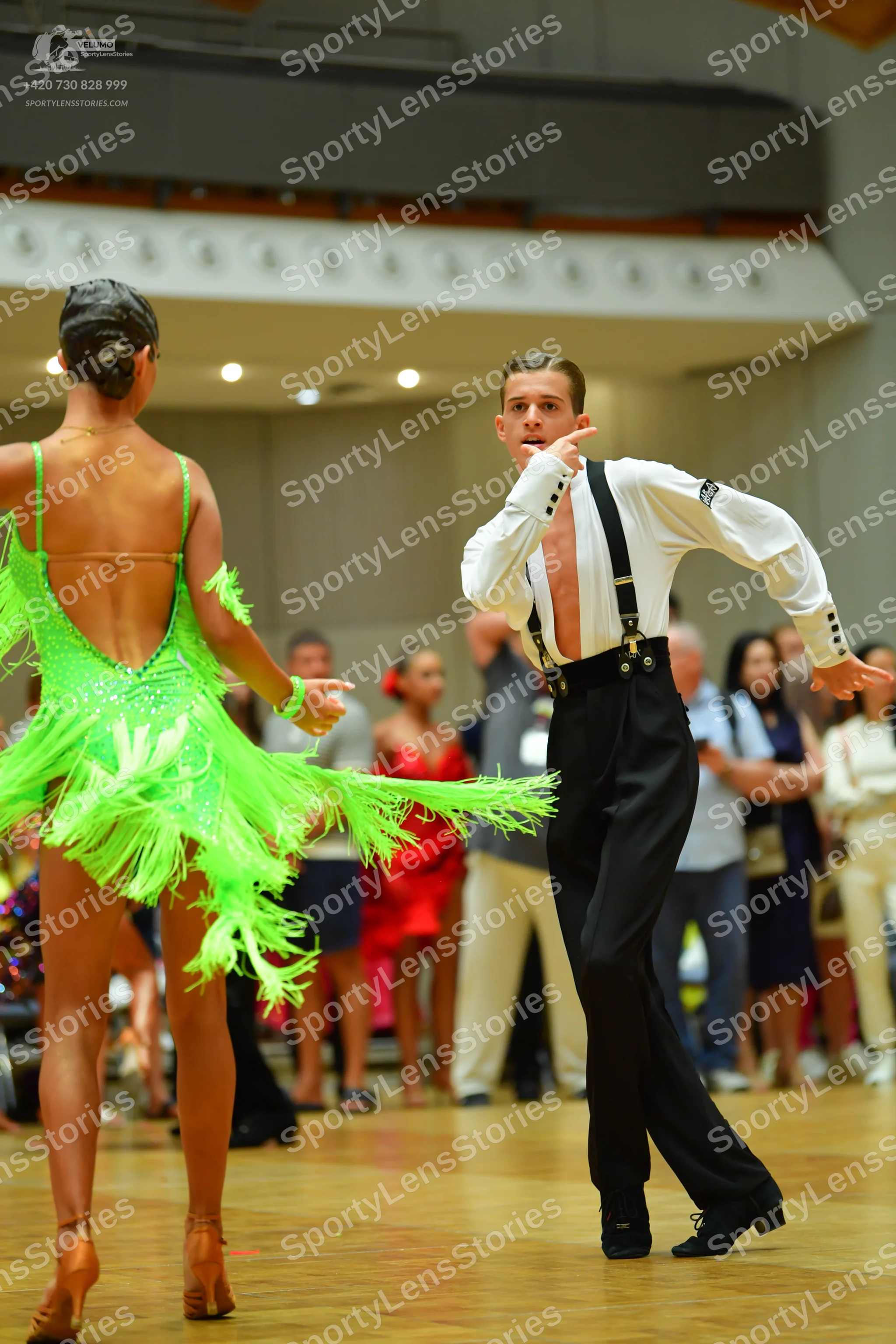 Dancesport competitor: Female dancer: bright lime green Latin dance dress with sequins and long fringe