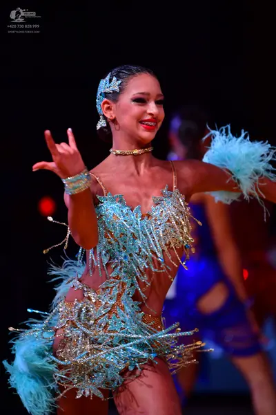 Dancesport competitor: Female dancer: light blue/aqua Latin dance dress with extensive sequin and bead 