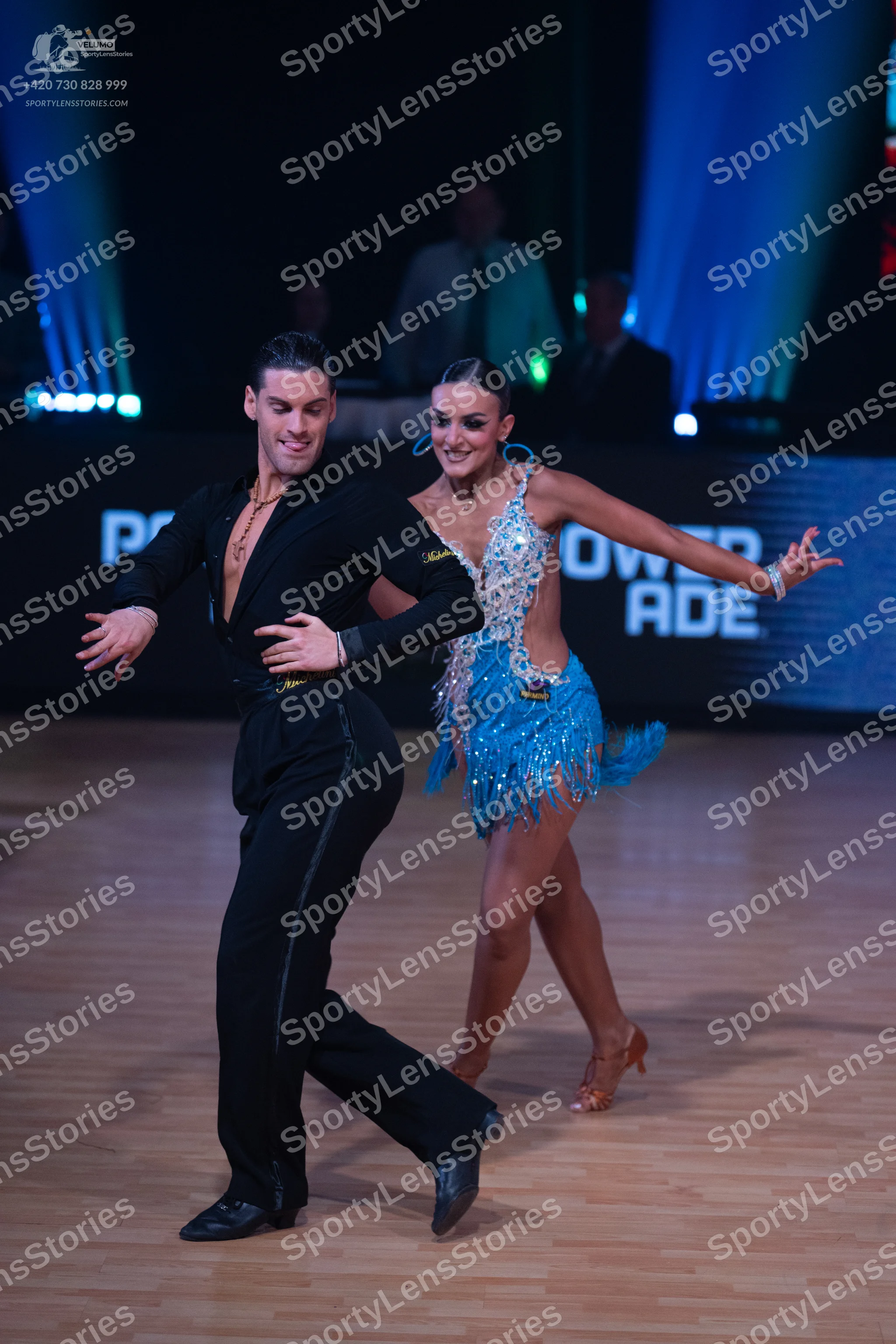 Dancesport competitor: Male dancer: black long-sleeved shirt and black trousers with a gold chain neckl