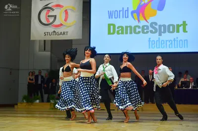 Dancesport competitor: Female dancer 1: black bra top and blue/white polka dot skirt