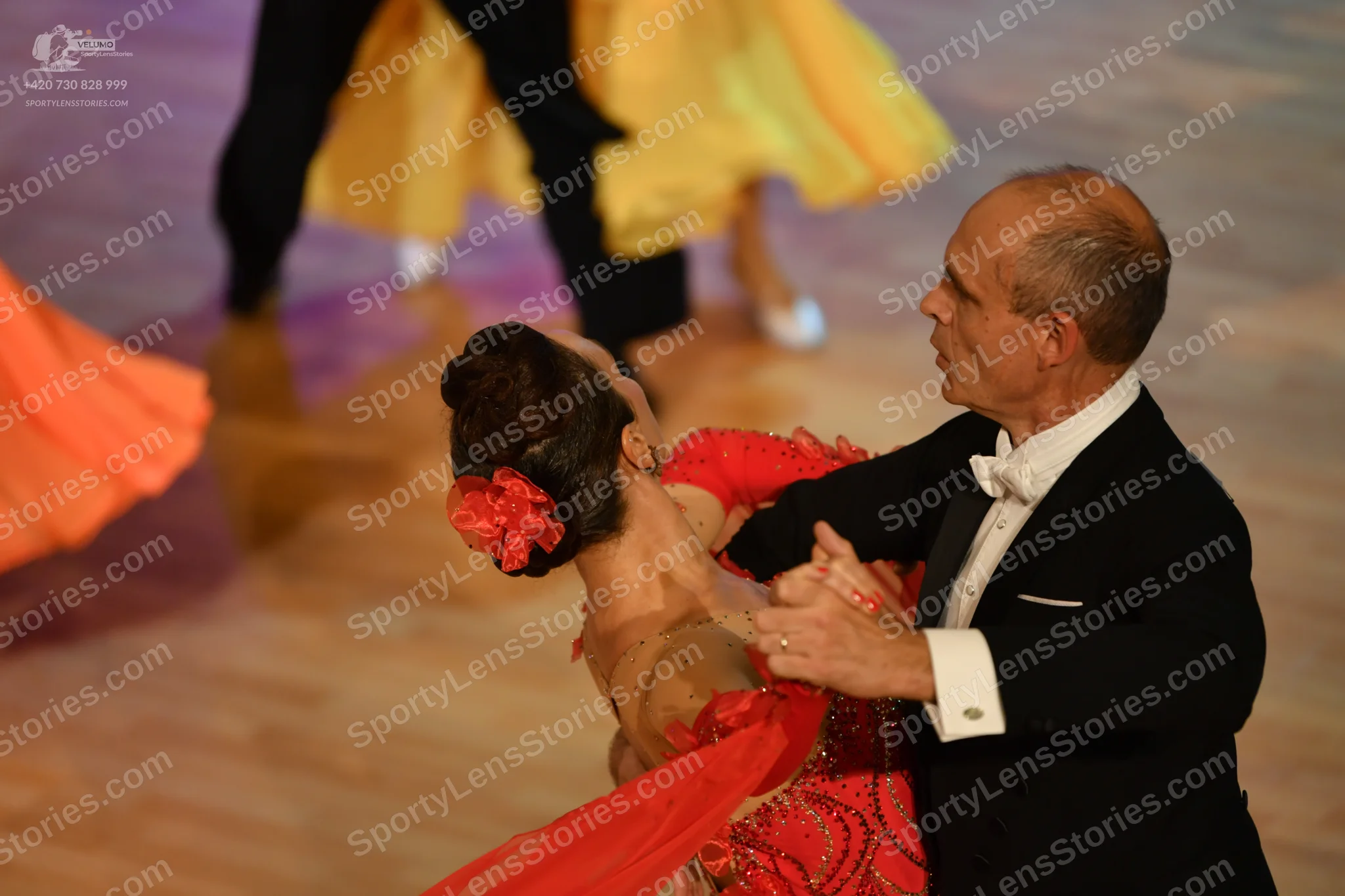 Dancesport competitor: Male:** Black tail suit with white satin shirt and a black bow tie