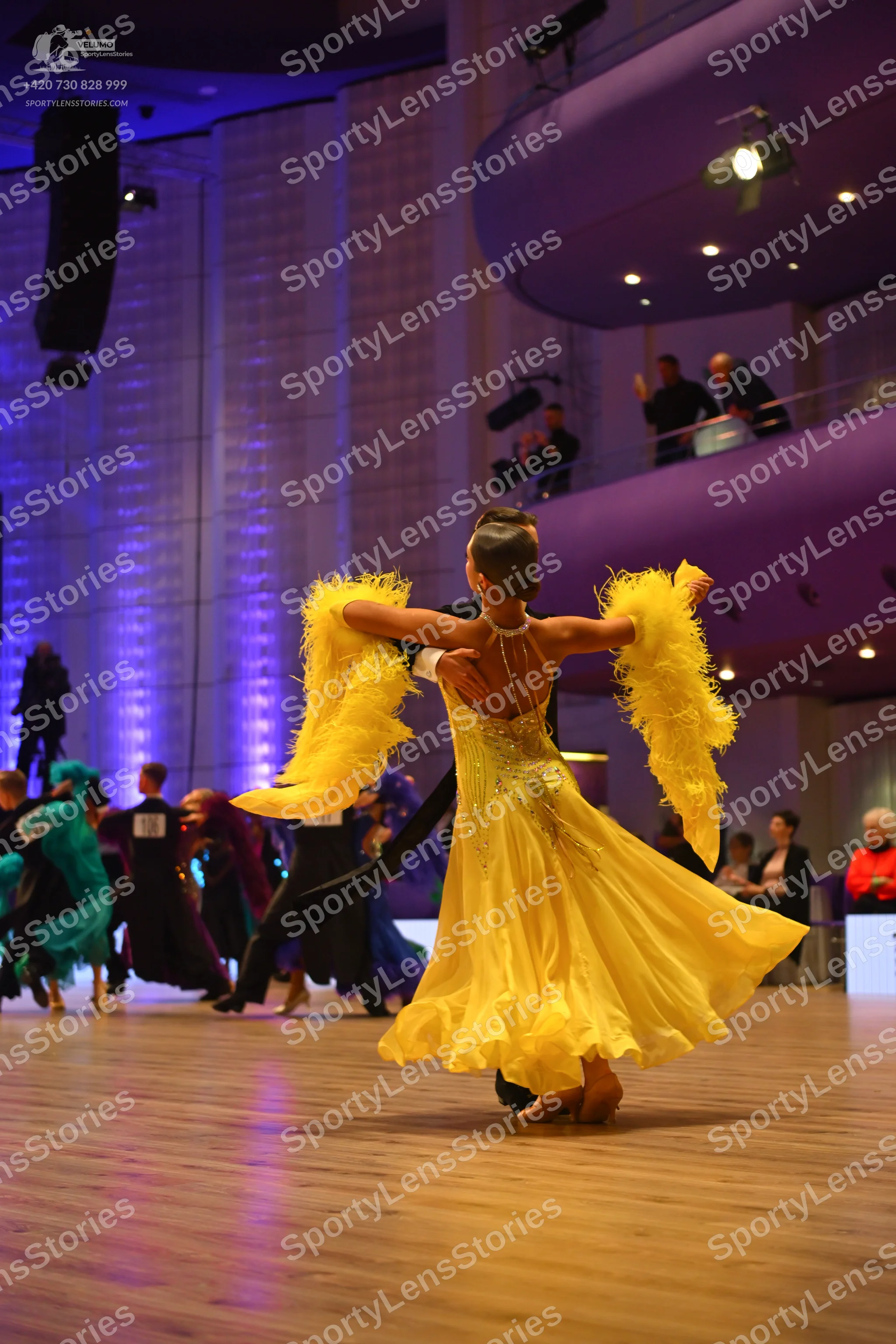 Dancesport competitor: Main dancer: yellow latin dress with a sequin-embellished bodice, a flowing skir