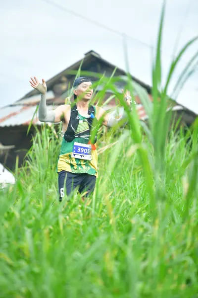 Marathon runner #3096: Runner 1: green and black patterned tank top, black shorts