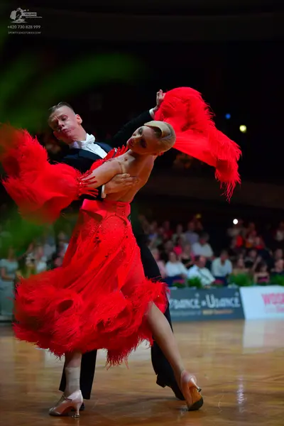 Dancesport competitor: Male dancer: black suit with a white shirt