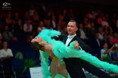 Dancesport competitor: Male dancer: black suit with white shirt and white bowtie