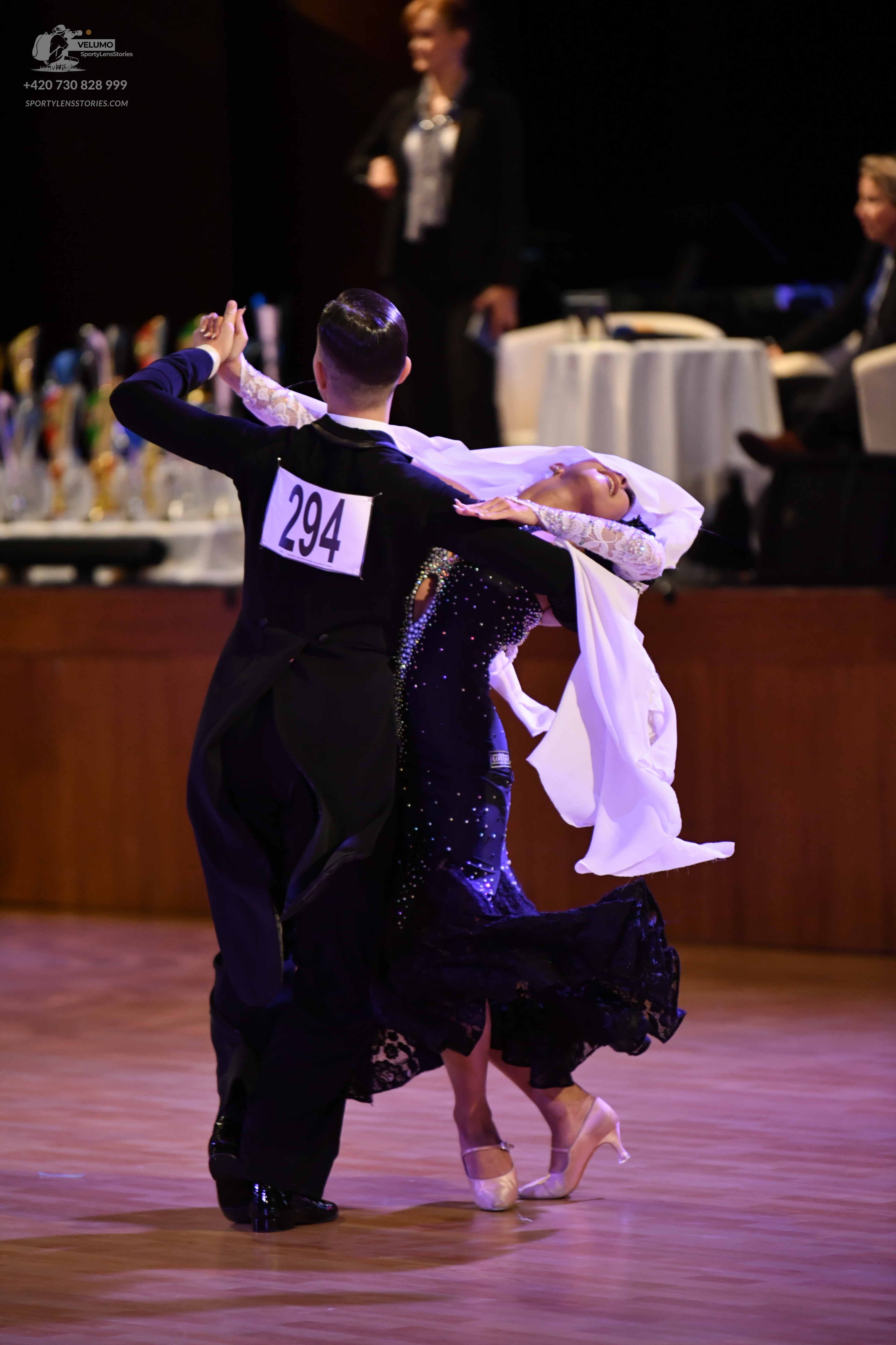 Dancesport competitor #294: ** Black tail suit
*   **Fabric:** Appears to be a satin or crepe fabric with a 