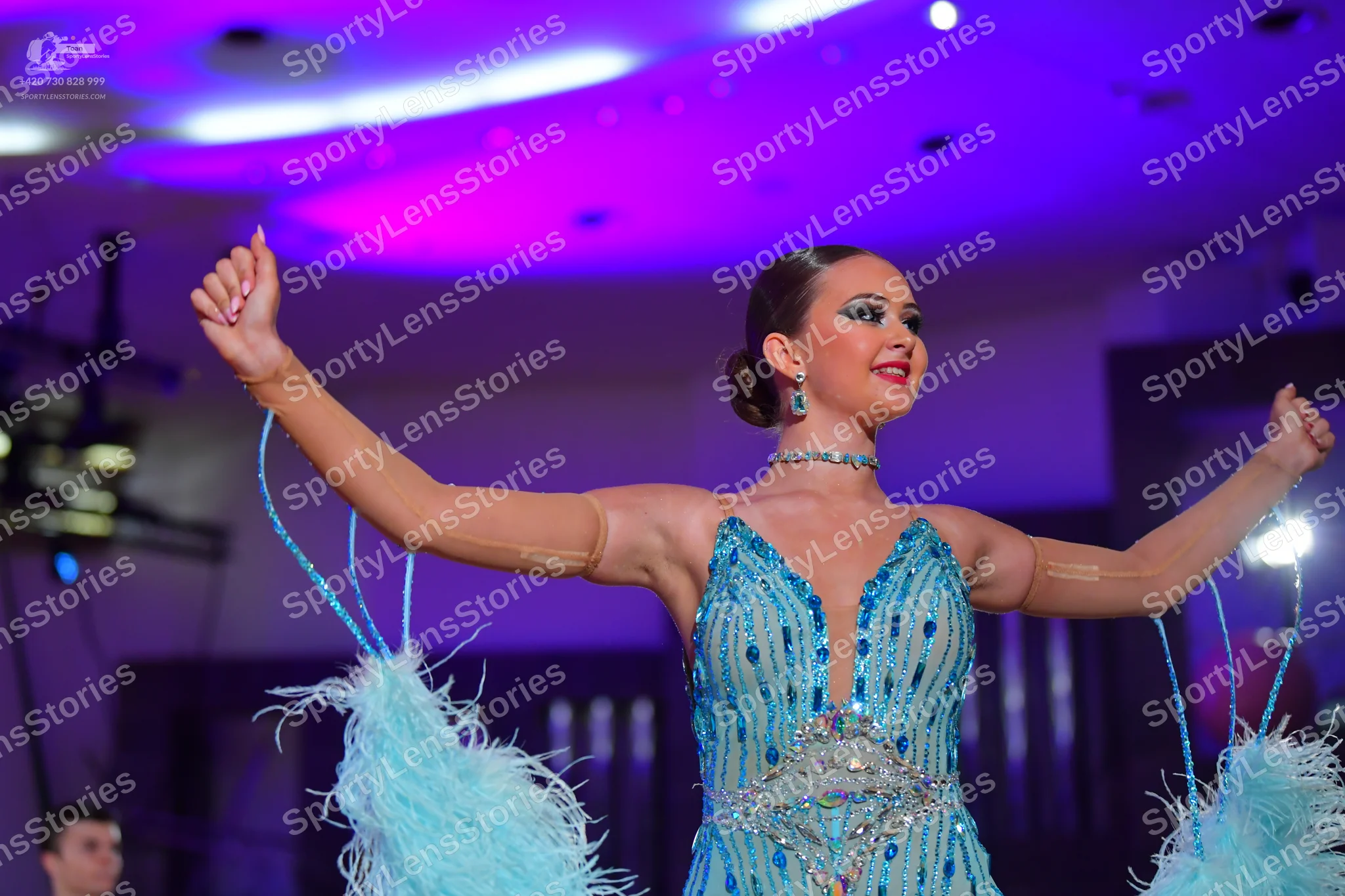 Dancesport competitor: Female dancer: light blue/cyan latin dance dress with heavy sequin and bead embe