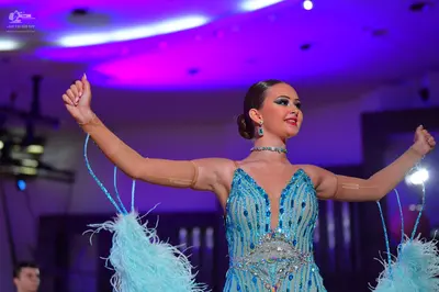 Dancesport competitor: Female dancer: light blue/cyan latin dance dress with heavy sequin and bead embe