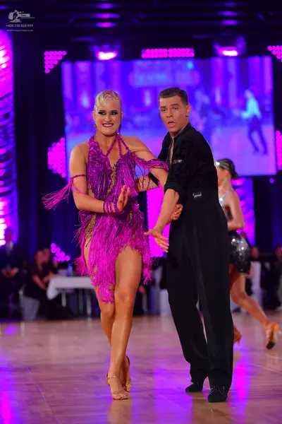 Dancesport competitor: Female dancer: purple Latin dress with fringe