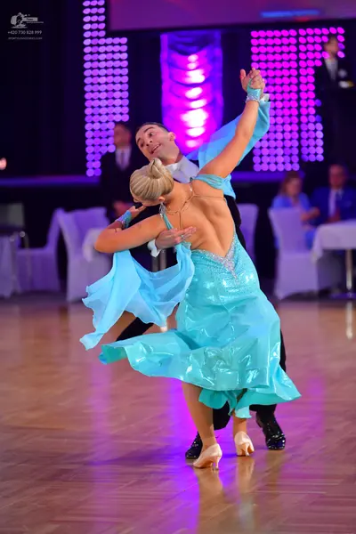 Dancesport competitor: Male dancer: black suit with a white shirt and bow tie