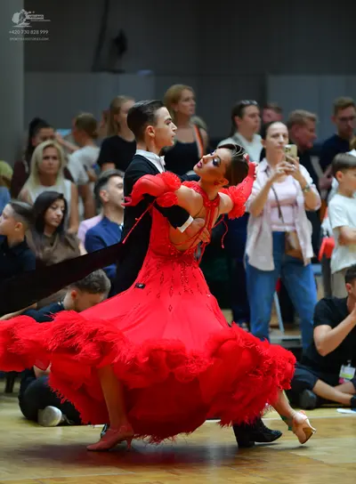 Dancesport competitor: Male dancer: black suit with a white shirt
