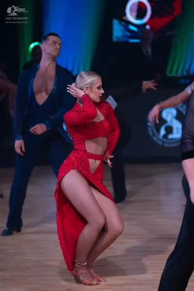 Dancesport competitor: Male dancer: dark blue long-sleeved shirt with a deep V-neck and matching trouse