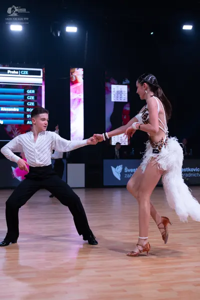 Dancesport competitor: Male dancer: white long-sleeved textured shirt and black trousers