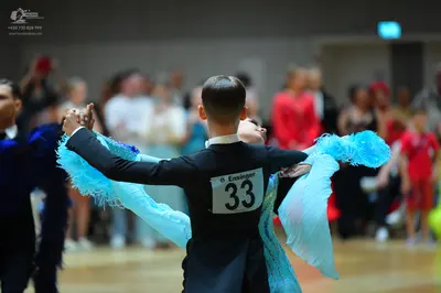 Dancesport competitor #33: Male dancer in center: black long-sleeved shirt and black trousers