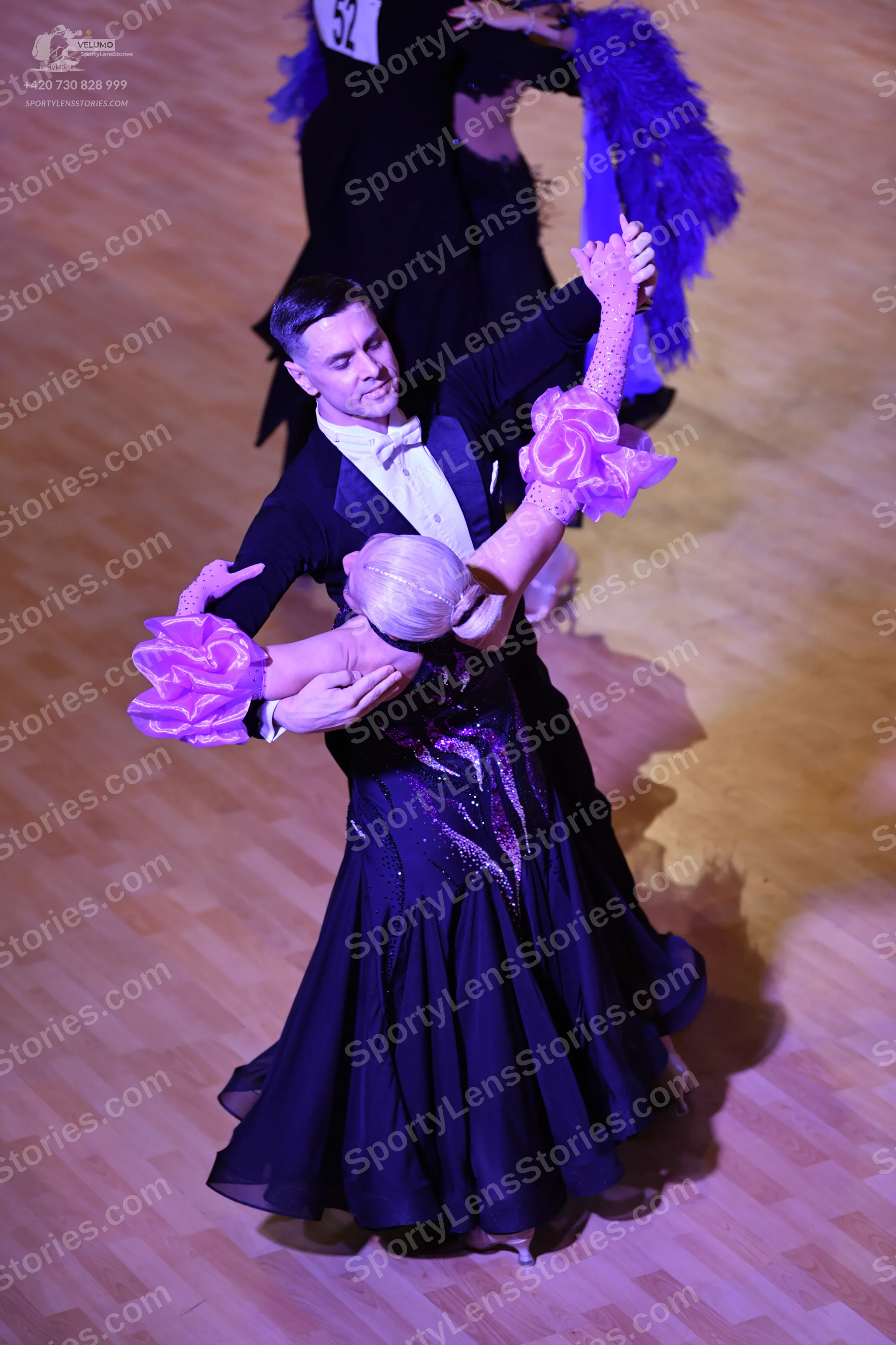 Dancesport competitor: Male:** Black tail suit with a white satin shirt and a white bow tie