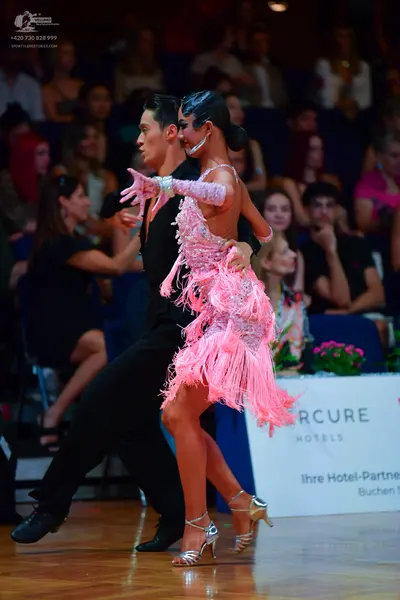 Dancesport competitor: Male dancer: black long-sleeved top and black trousers
