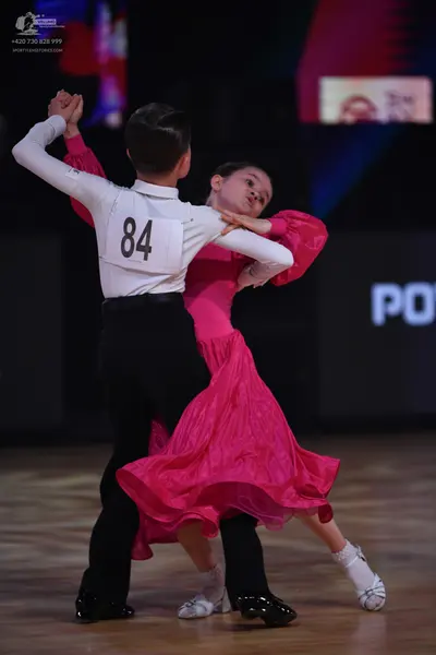 Dancesport competitor: Male dancer: white long-sleeved shirt, black trousers, and black dance shoes