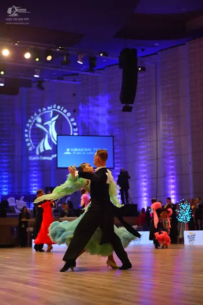 Dancesport competitor: Male dancer: black suit with white shirt
