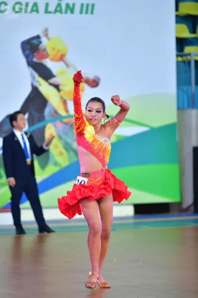 Dancesport competitor: ** Red Latin dress
*   **Color:** Primarily red with yellow detailing