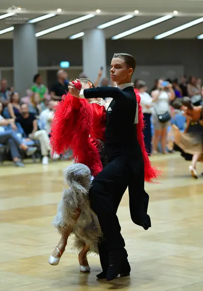Dancesport competitor: Male dancer: black long-sleeve shirt and black trousers