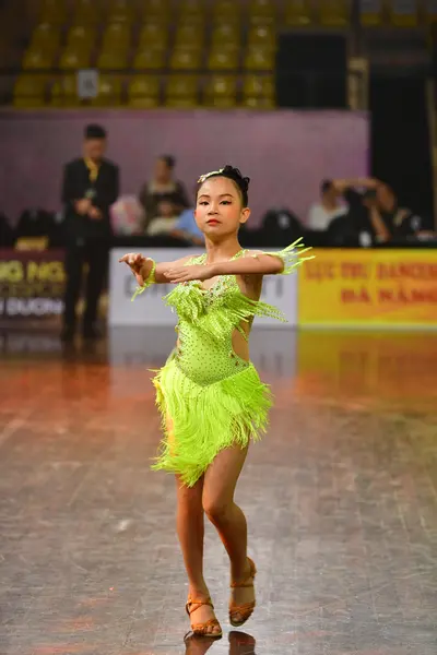 Dancesport competitor: Female dancer: neon lime green latin dress with fringe and sequins