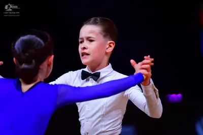 Dancesport competitor: Female dancer: royal blue long-sleeved latin dress