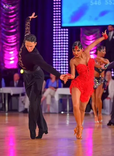 Dancesport competitor: Male dancer: black long-sleeved shirt with a patterned sleeve and black trousers
