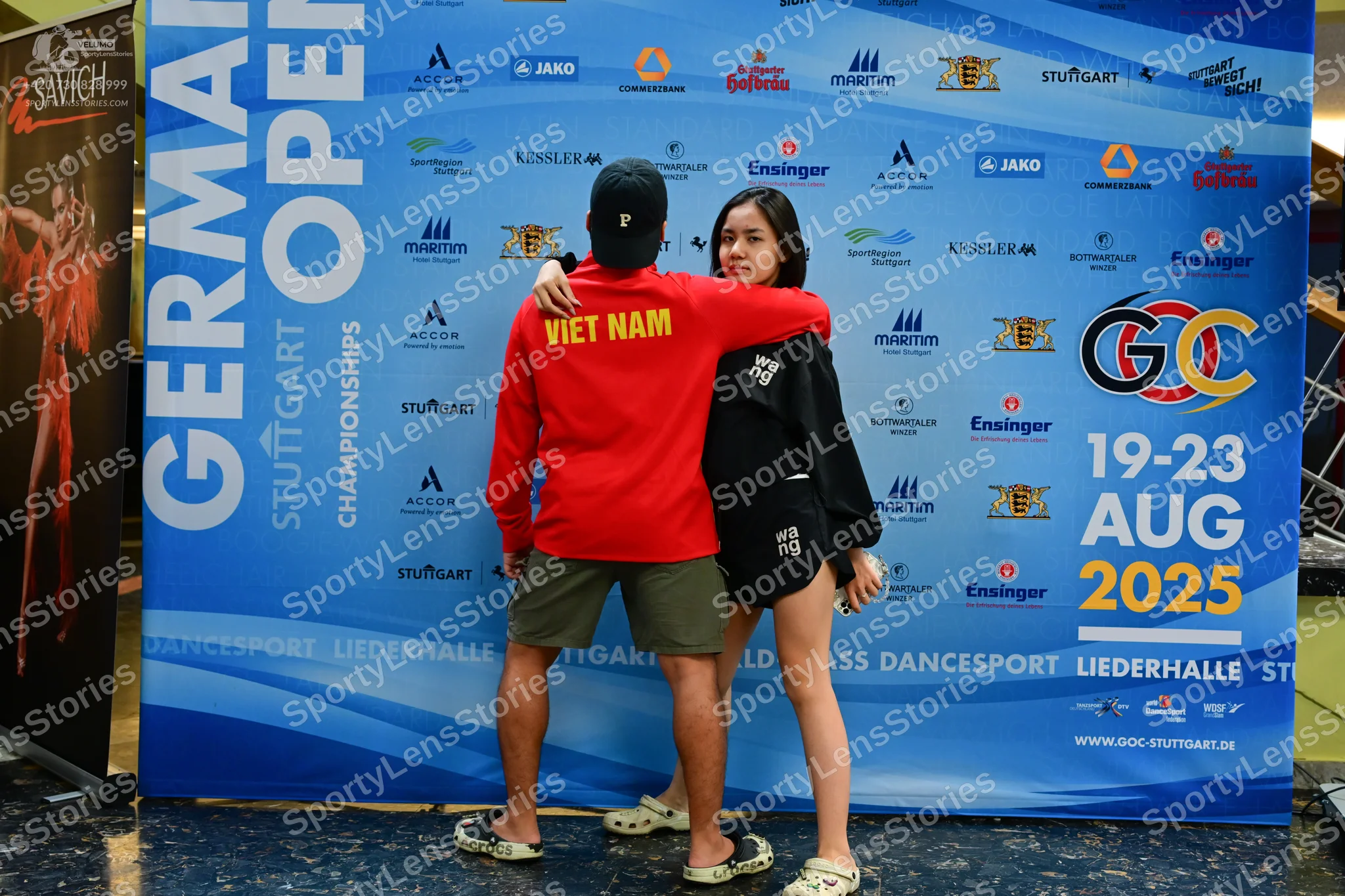 Dancesport competitor: Male dancer: red long-sleeved sweatshirt with "VIET NAM" in yellow on the back,