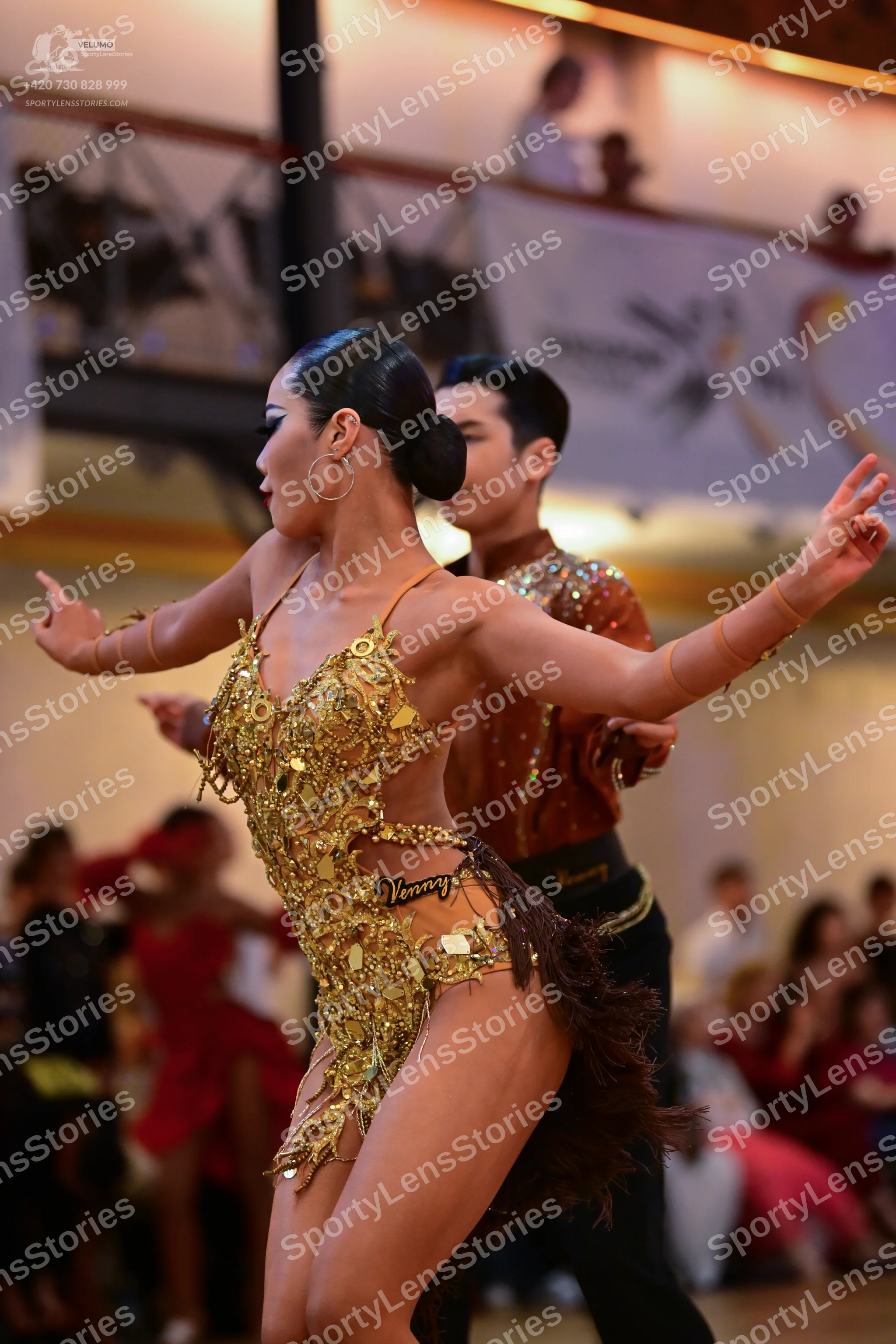 Dancesport competitor: Male dancer: bronze-colored shirt with heavy sequin and crystal embellishments,