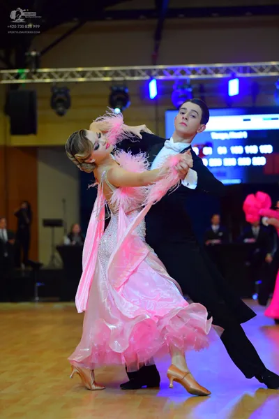 Dancesport competitor: Male dancer: black suit with a white shirt and white bowtie