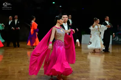Dancesport competitor: Central male dancer: black suit with a white shirt and black bowtie