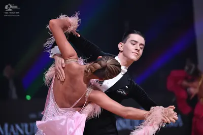 Dancesport competitor: Male dancer: black suit with white shirt and white bowtie