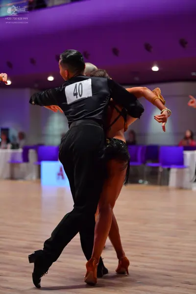Dancesport competitor: Male dancer: black long-sleeved shirt and black trousers