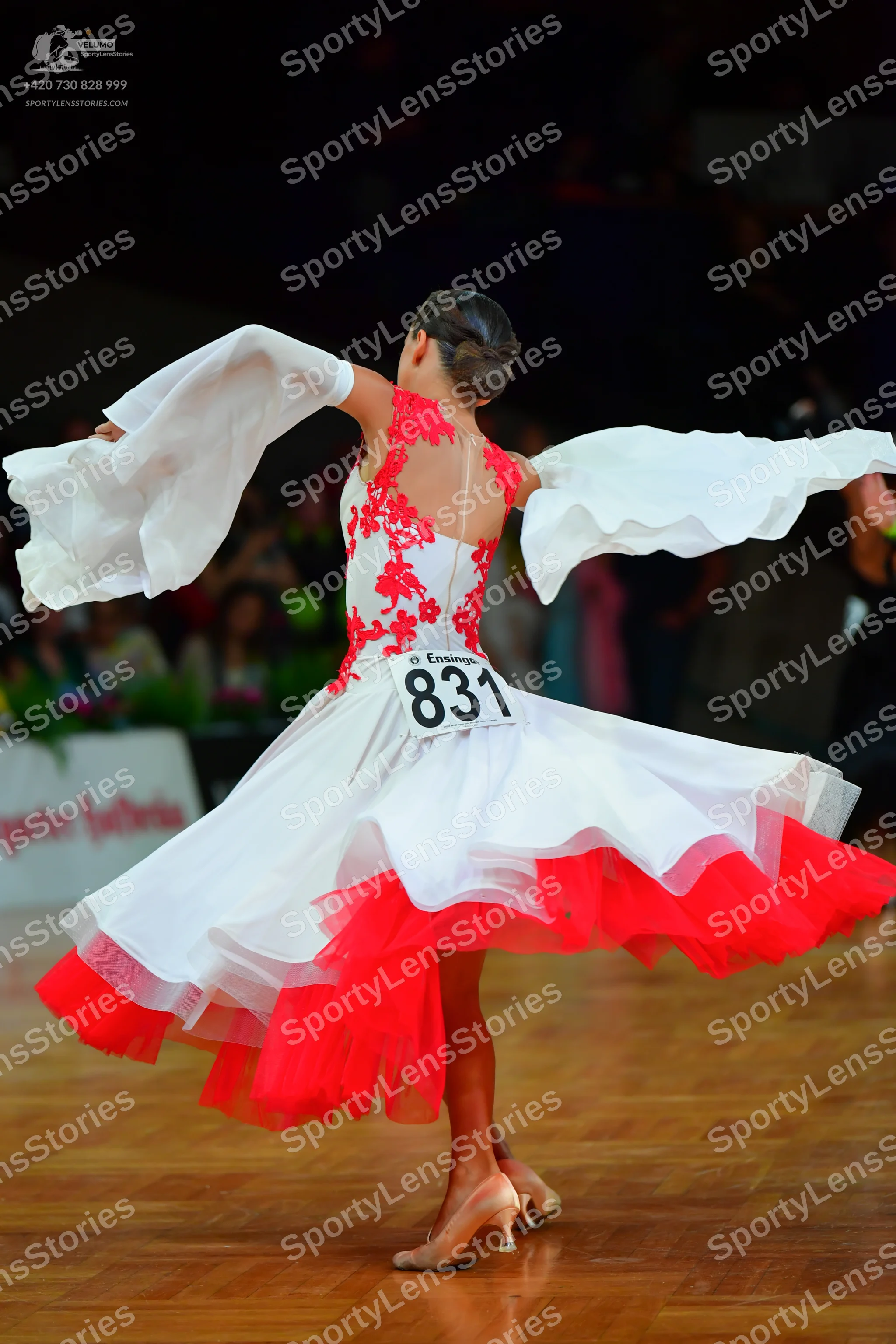 Dancesport competitor: Female dancer: white ballroom dress with red lace floral patterns on the bodice,