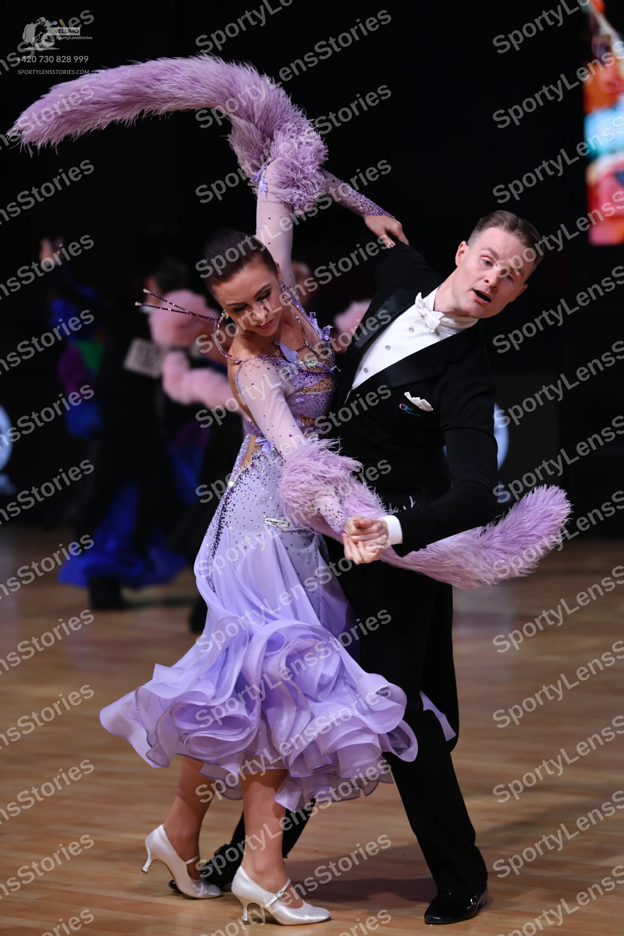 Dancesport competitor: Female dancer: light purple ballroom gown with a voluminous ruffled skirt and a