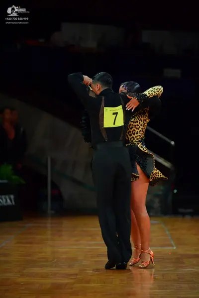 Dancesport competitor: Male dancer: black long-sleeved shirt and black trousers
