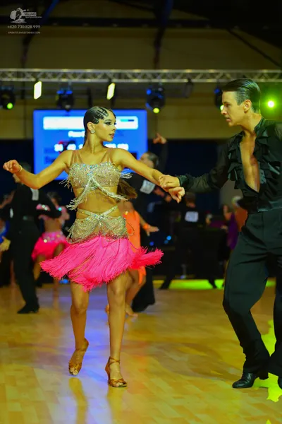 Dancesport competitor: Female dancer: champagne-colored Latin costume with a sequined, embellished top 