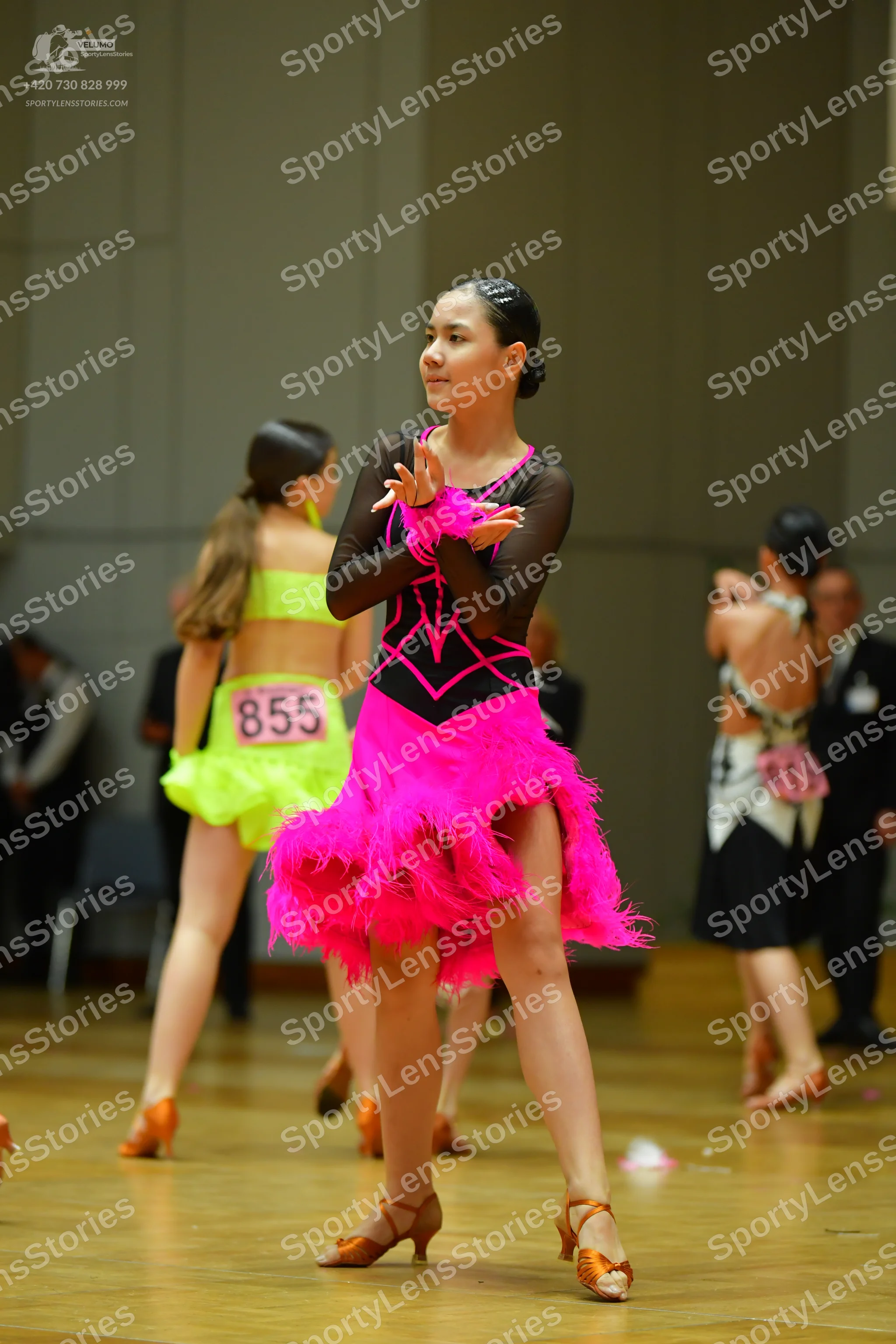 Dancesport competitor #855: Female dancer: lime green Latin dress with a crop top and ruffled skirt; black l