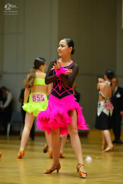 Dancesport competitor #855: Female dancer: lime green Latin dress with a crop top and ruffled skirt; black l