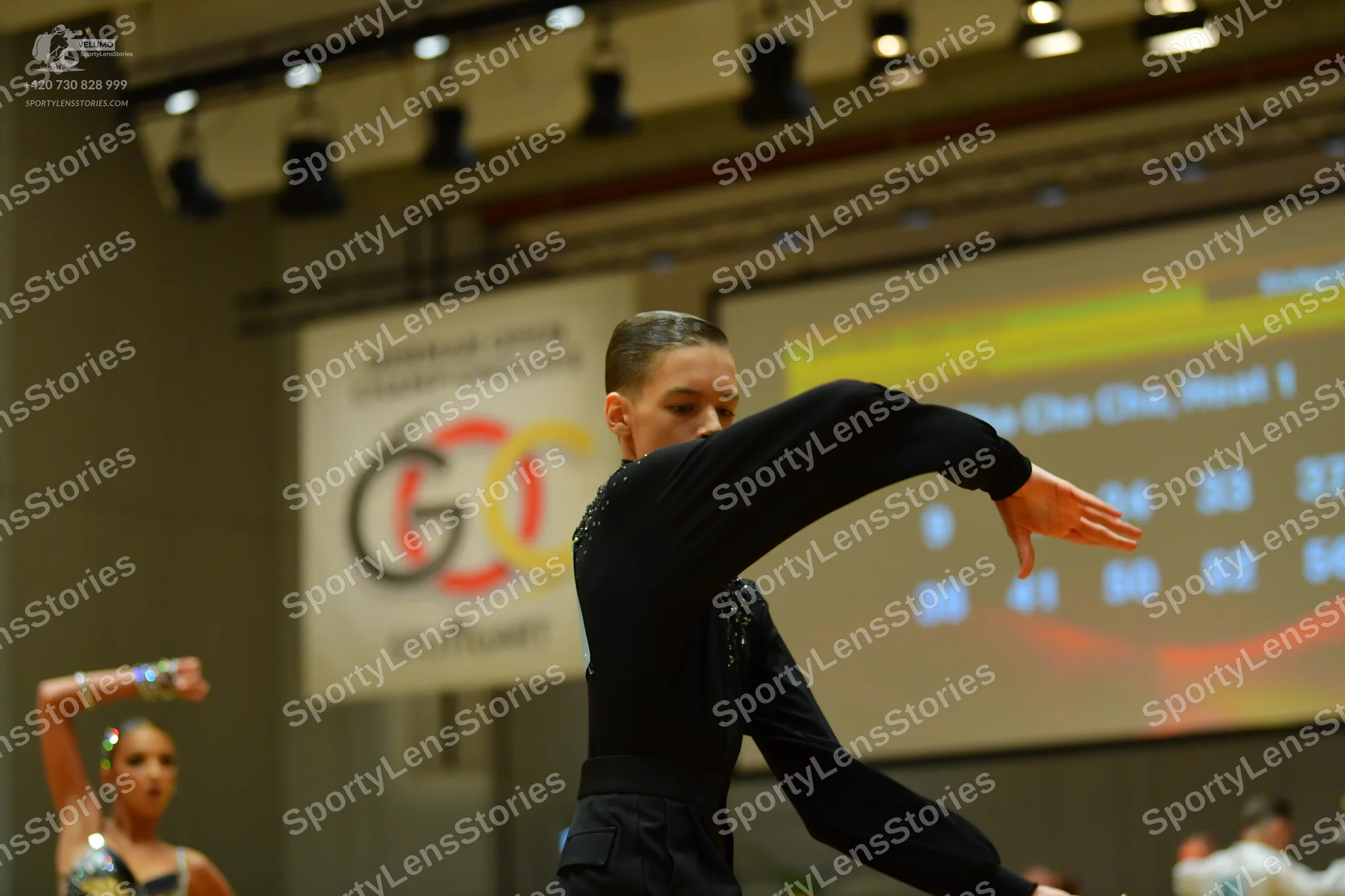 Dancesport competitor: Male dancer: black long-sleeved top with subtle sequin details and black pants